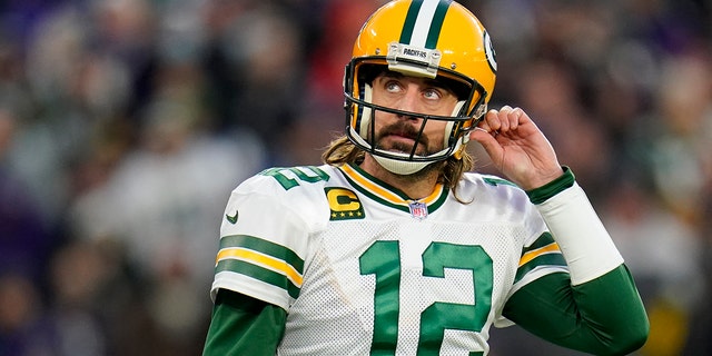 Green Bay Packers quarterback Aaron Rodgers walks off the field after not being able to convert for a first down in the first half of an NFL football game against the Baltimore Ravens, Sunday, Dec. 19, 2021, in Baltimore.