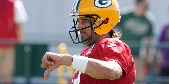 Green Bay Packers' Aaron Rodgers gestures before an NFL football joint practice session with the New Orleans Saints Tuesday, Aug. 16, 2022, in Green Bay, Wisconsin.