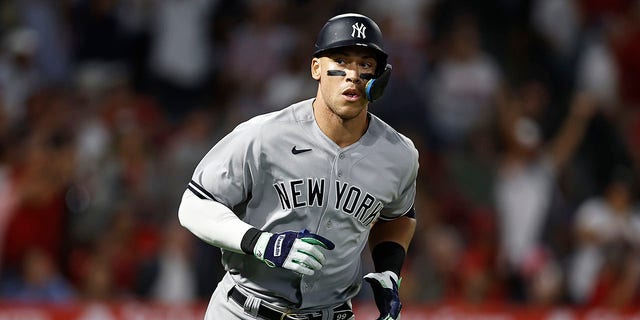 Aaron Judge, #99 of the New York Yankees, rounds the bases after hitting his 50th home run of the season against the Los Angeles Angels during the eighth inning at Angel Stadium of Anaheim on August 29, 2022 in Anaheim, California.