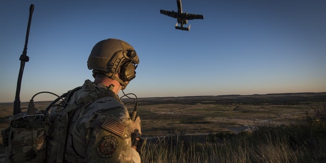 A Tactical Control Party Airmen and qualified Joint Terminal Aircraft Controller assigned to the 9th Air Support Operations Squadron at Fort Hood, Texas, directs an A-10 Thunderbolt II aircraft during a close-air-support exercise at Fort Hood, Texas Oct. 30, 2020.