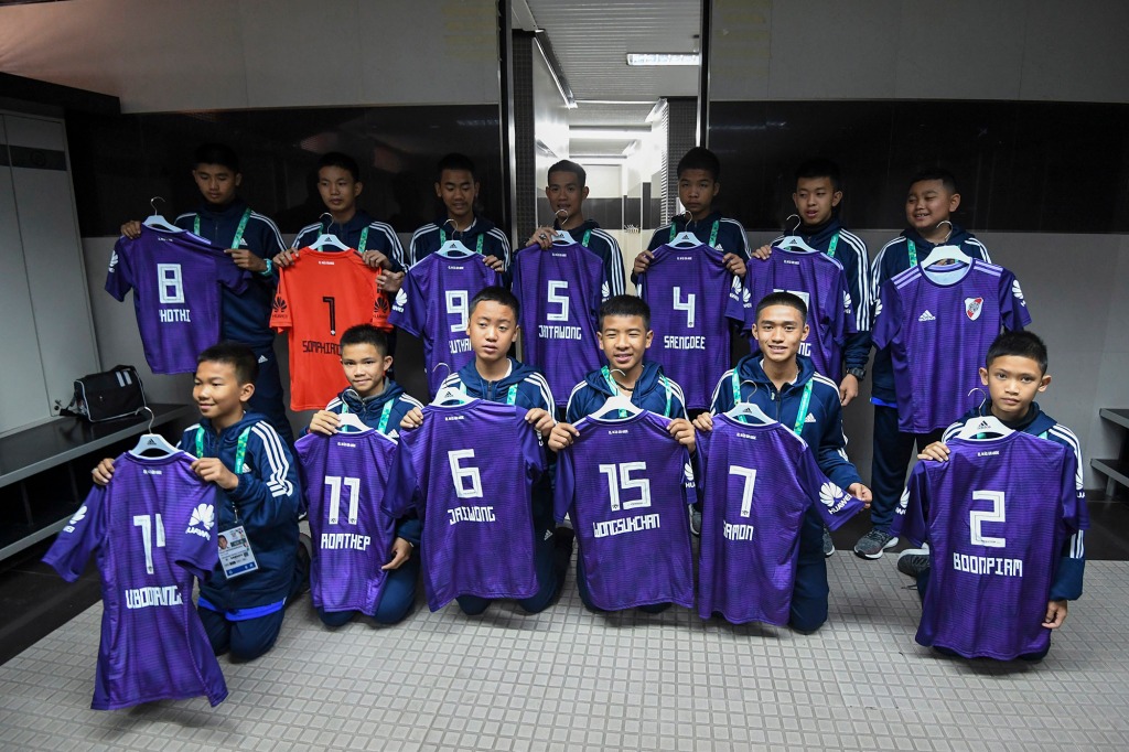 The real Thai team, called the Wild Boars, posing with their soccer uniforms.