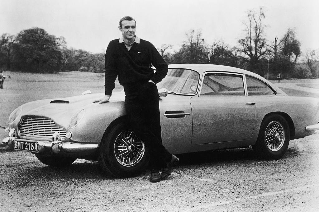 Actor Sean Connery, the original James Bond, is pictured here on the set of Goldfinger with one of the fictional spy's cars, a 1964 Aston Martin DB5.
