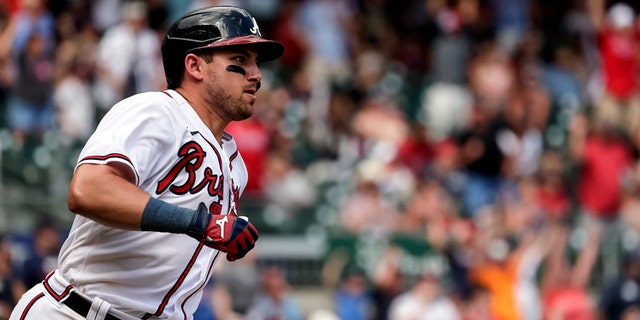 Atlanta Braves' Austin Riley runs to first on a game-winning RBI during the ninth inning against the Arizona Diamondbacks, July 31, 2022, in Atlanta.