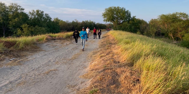 People who crossed the U.S.-Mexico border illegally search for Border Patrol in La Joya, Texas.