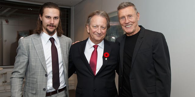 Ottawa Senators owner Eugene Melnyk, center, poses for a photo with Erik Karlsson, left, and Börje Salming at the Canadian Embassy on Nov. 7, 2017, in Stockholm, Sweden.