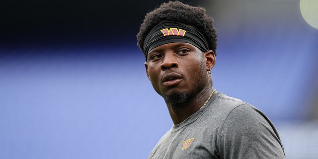 Brian Robinson of the Washington Commanders warms up before the preseason game against the Baltimore Ravens in Baltimore, Maryland, on Aug. 27, 2022.