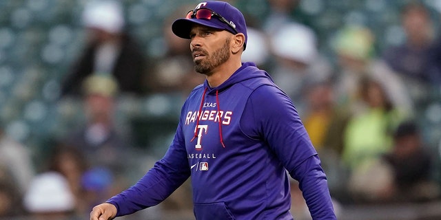 FILE - Texas Rangers manager Chris Woodward is shown during a game against the Oakland Athletics in Oakland, California.