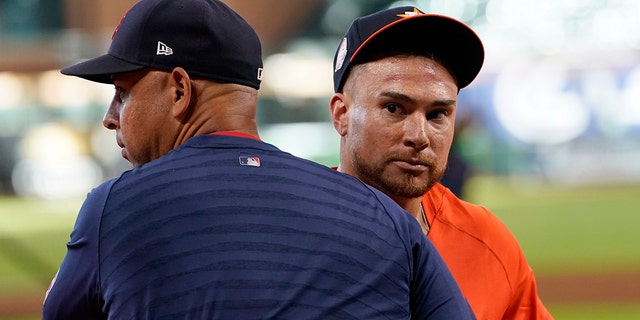 Boston Red Sox manager Alex Cora, left, and Houston Astros' Christian Vazquez hug before a game, Tuesday, Aug. 2, 2022, in Houston. Vazquez was traded from the Red Sox to the Astros on Monday.