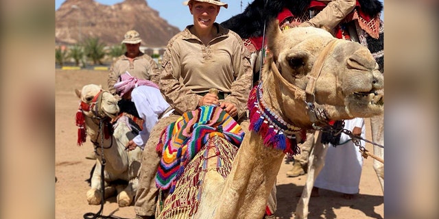 Gee rides a camel in Saudi Arabia.