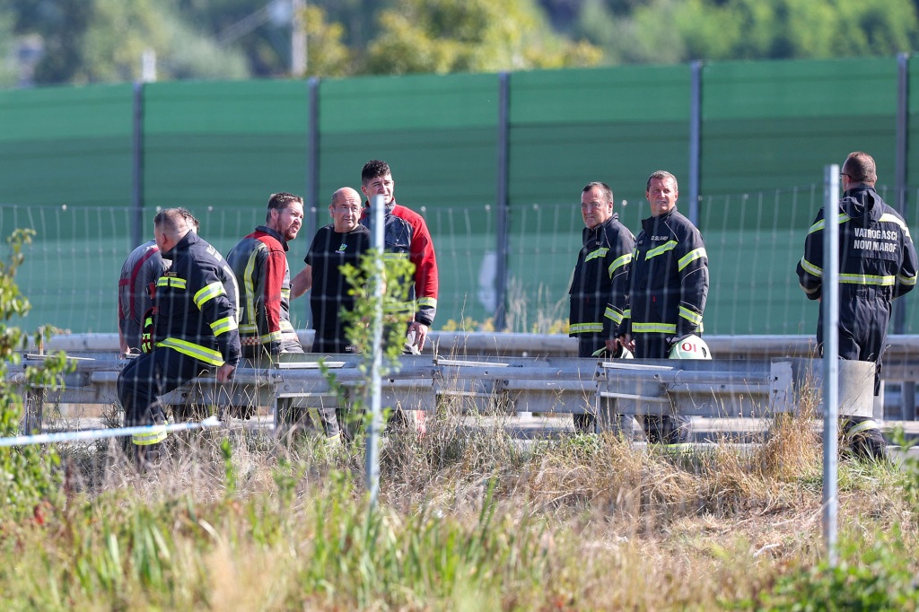 Emergency services stand on the Varazdin-Zagreb highway next to the wreckage of the bus after the accident that happened on August 6, 2022.