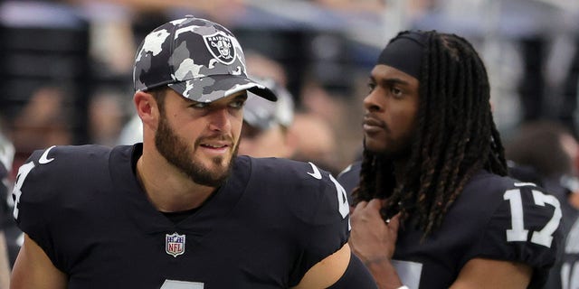 Quarterback Derek Carr (4) and wide receiver Davante Adams (17) of the Las Vegas Raiders stand on a sideline during a preseason game against the Minnesota Vikings at Allegiant Stadium Aug. 14, 2022, in Las Vegas. The Raiders defeated the Vikings 26-20.