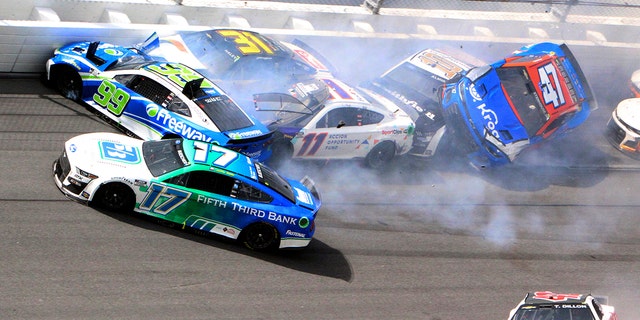 Chris Buescher (17), Daniel Suarez (99), Denny Hamlin (11), Justin Haley (31), Ty Dillon (42), Aric Almirola (10) and Ricky Stenhouse Jr. (47) are involved in a multi-car accident at Daytona International Speedway, Sunday, Aug. 28, 2022.