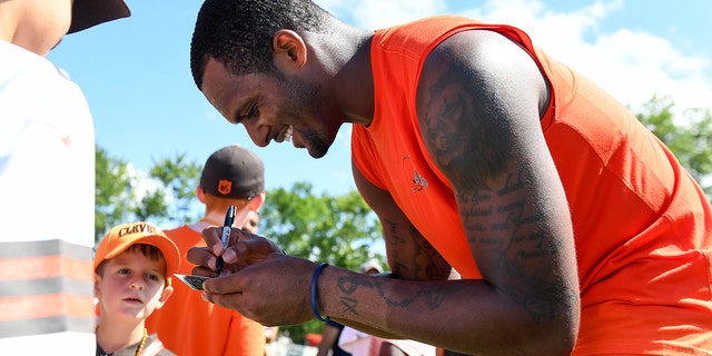 Deshaun Watson #4 of the Cleveland Browns signs autographs after Cleveland Browns training camp at CrossCountry Mortgage Campus on July 30, 2022 in Berea, Ohio.