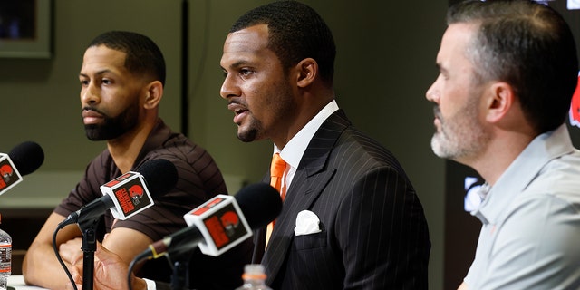 Cleveland Browns new quarterback Deshaun Watson, center, speaks during a news conference at the NFL football team's training facility as general manager Andrew Berry, left, and head coach Kevin Stefanski listen, Friday, March 25, 2022, in Berea, Ohio.