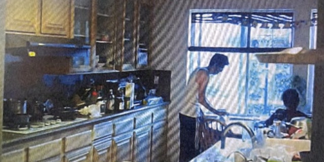 In a series of screengrabs from video, Dr. Chen puts his drink down in the kitchen.