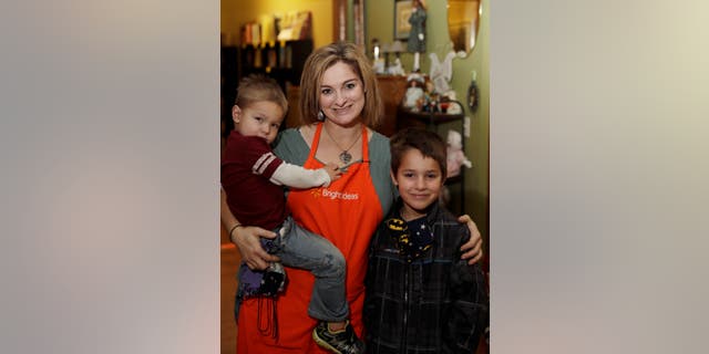 A mother and her two children receive food at Feeding South Dakota