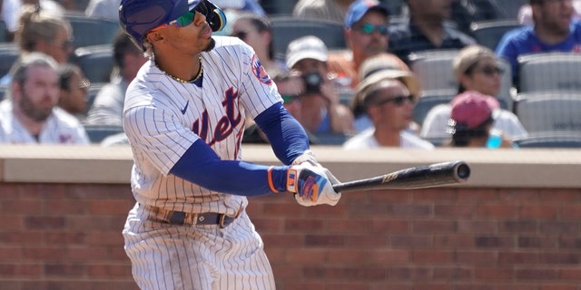 New York Mets' Francisco Lindor watches the ball after hitting an RBI double in the sixth inning of the first game of a doubleheader against the Atlanta Braves, Aug. 6, 2022, in New York.