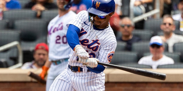 New York Mets' Francisco Lindor singles on a fly ball during the first inning of a baseball game against the Philadelphia Phillies, Sunday, Aug. 14, 2022, in New York.