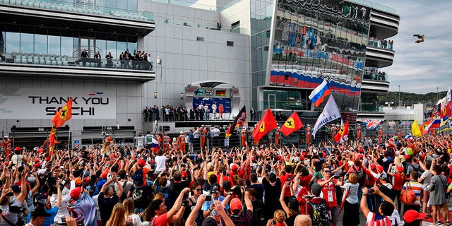 Winner Mercedes' British driver Lewis Hamilton, second placed Mercedes' Finnish driver Valtteri Bottas and third placed Ferrari's German driver Sebastian Vettel celebrate during the podium ceremony for the Formula One Russian Grand Prix at the Sochi Autodrom circuit in Sochi on September 30, 2018. 