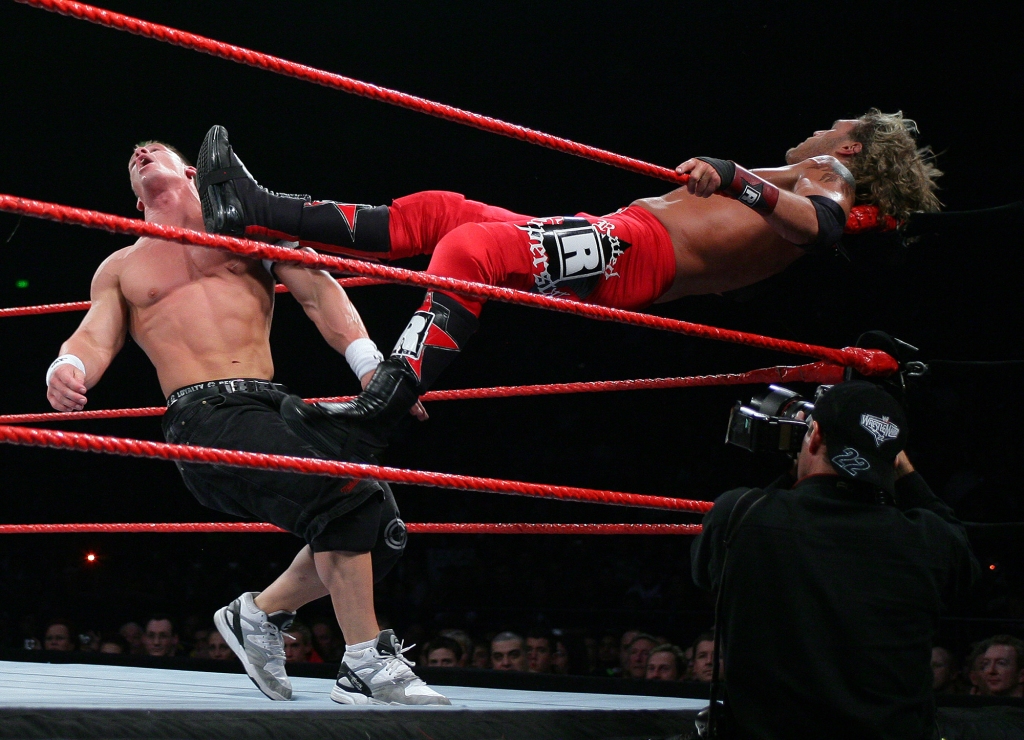 John Cena is dealt another telling blow by  Edge Lita during the WWE RAW Superslam in 2006.