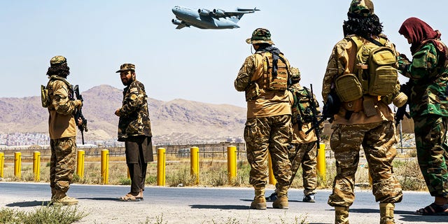 A C-17 Globemaster takes off as Taliban fighters secure the outer perimeter of the Hamid Karzai International Airport in Kabul, Afghanistan, Aug. 29, 2021.