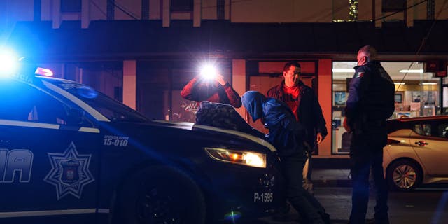 Police officers arrest a resident for alleged robbery in Tijuana, Mexico, on Thursday, Feb. 10, 2022. 