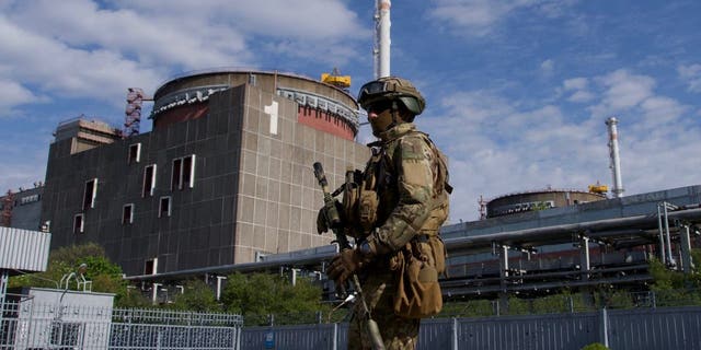 A Russian serviceman patrols the territory of the Zaporizhzhia Nuclear Power Station in Energodar on May 1, 2022.