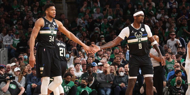 Giannis Antetokounmpo #34 of the Milwaukee Bucks hi-fives Bobby Portis #9 during Game 5 of the 2022 NBA Playoffs Eastern Conference Semifinals on May 11, 2022 at the TD Garden in Boston, Massachusetts.  