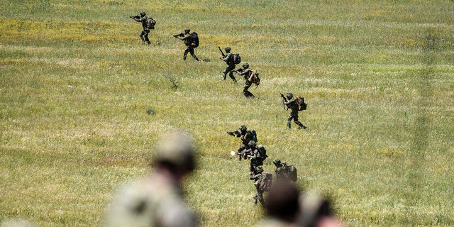 British soldiers take part in the Swift Response 22 military exercise at the Krivolak Military Training Center in Negotino, in the centre of North Macedonia, on May 12, 2022. The excercise, which involves approximately 4,600 soldiers from North Macedonia, Albania, Montenegro, Greece, Italy, as well as France, the UK and the US, is meant to show that NATO forces can be deployed and fully cooperate. 