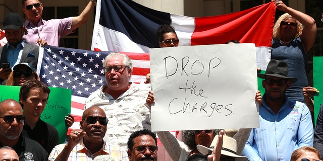 Members of the Dominican Republic community, bodega owners and different associations are pictured on the steps of City Hall during press conference asking Manhattan D. A. Alvin Bragg to drop charges against bodega worker Jose Alba.