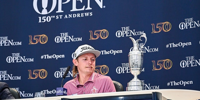 Cameron Smith of Australia looks at the Claret Jug trophy during a press conference following his one stroke victory in the final round of The 150th Open Championship on The Old Course at St Andrews on July 17, 2022 in St. Andrews, Scotland. 