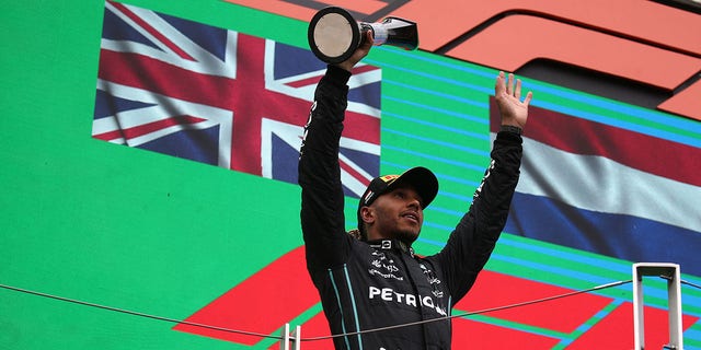 Lewis Hamilton of the Mercedes AMG Petronas F1 Team celebrates on the podium at the end of the F1 Grand Prix of Hungary.  