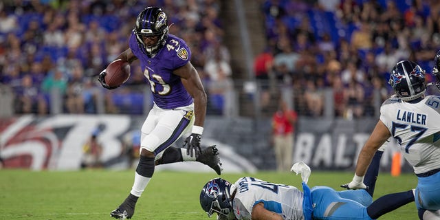 Baltimore Ravens running back Justice Hill breaks free out of the backfield during an NFL preseason game against the Tennessee Titans at M and T Bank Stadium in Baltimore, Maryland, on Aug. 11, 2022.