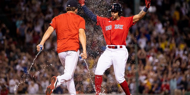 Tommy Pham (22) of the Boston Red Sox celebrates after hitting a game-winning walk-off RBI single during the 10th inning against the New York Yankees Aug. 12, 2022, at Fenway Park in Boston.