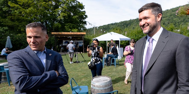 Marc Molinaro and Pat Ryan talk before the start of a candidate forum at the Roscoe Beer Co. in Roscoe, New York, on Thursday, Aug. 18, 2022.