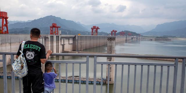 The Three Gorges Dam and low water levels along the Yangtze River in Yichang, China, on Tuesday, Aug. 23, 2022.  