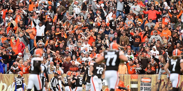 Fans cheer as Baker Mayfield of the Cleveland Browns celebrates a touchdown with teammates at the end of the second quarter against the Arizona Cardinals at FirstEnergy Stadium in Cleveland, Ohio, on Oct. 17, 2021.