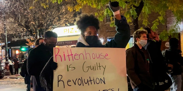 A protester holds a "Rittenhouse is guilty" sign during a protest against the acquittal of Kyle Rittenhouse in the West Village on Nov. 19, 2021, in New York City.