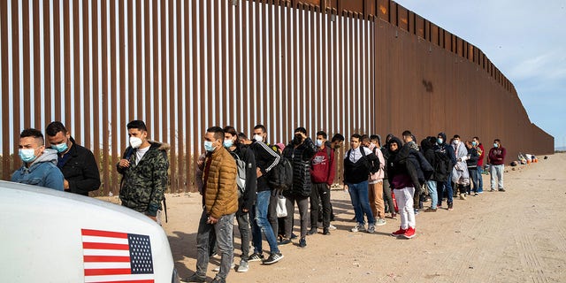 Migrants pictured on April 1, 2022, at the U.S.-Mexico border. 