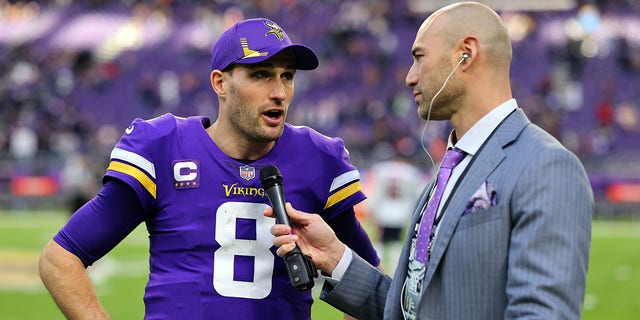 Minnesota Vikings quarterback Kirk Cousins is interviewed by NFL sideline reporter Ben Leber after a 31-17 win over the Chicago Bears at U.S. Bank Stadium in Minneapolis, Minnesota, on Jan. 9, 2022.