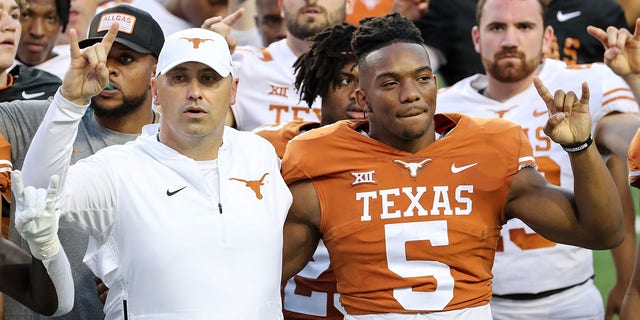 Head coach Steve Sarkisian of Texas Longhorns stands Bijan Robinson, #5, during the Eyes of Texas after the Orange-White Spring Game at Darrell K Royal-Texas Memorial Stadium on April 23, 2022 in Austin, Texas. 