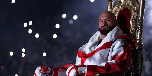 Tyson Fury sits on a throne before entering the ring prior to the WBC world heavyweight title fight against Dillian Whyte at Wembley Stadium April 23, 2022, in London. 