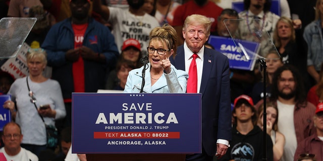 Republican U.S. House candidate and former Alaska Gov. Sarah Palin speaks as former President Trump looks on during a rally at Alaska Airlines Center on July 09, 2022 in Anchorage, Alaska.