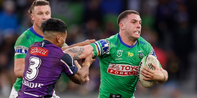 Adam Elliott of the Canberra Raiders stiff-arms Marion Seve during a round 18 NRL match against the Melbourne Storm at AAMI Park July 17, 2022, in Melbourne, Australia. 