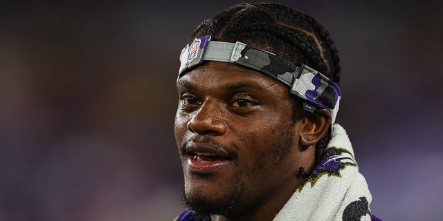 Lamar Jackson of the Baltimore Ravens looks on from the sidelines during the second half against the Tennessee Titans at M and T Bank Stadium in Baltimore, Maryland, on Aug. 11, 2022.