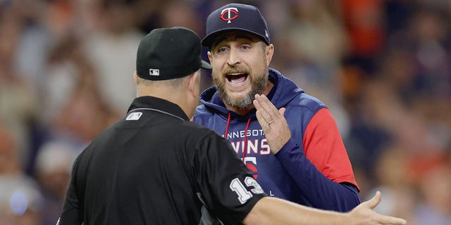 Rocco Baldelli #5 of the Minnesota Twins argues a call with umpire Todd Tichenor #13 on removing pitcher Aaron Sanchez #43 during the fifth inning at Minute Maid Park on Aug. 23, 2022 in Houston, Texas. 