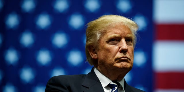 Former President Donald Trump looks on during a rally at the DeltaPlex Arena in Grand Rapids, Michigan.