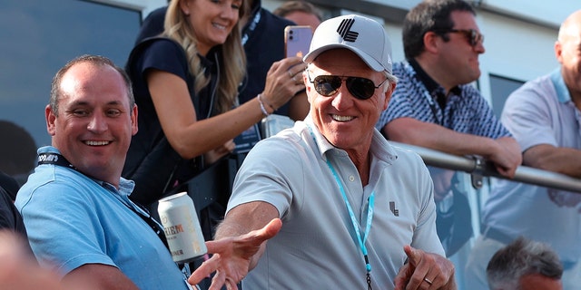 LIV Golf CEO Greg Norman tosses beers to spectators at the 18th green during the Portland Invitational LIV Golf tournament in North Plains, Oregon, on July 2, 2022.