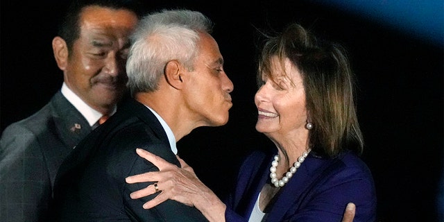 U.S. House Speaker Nancy Pelosi is greeted by U.S. Ambassador to Japan Rahm Emanuel, on her arrival at the U.S. Yokota Air Base, in Fussa on the outskirts of Tokyo, Aug. 4, 2022. 