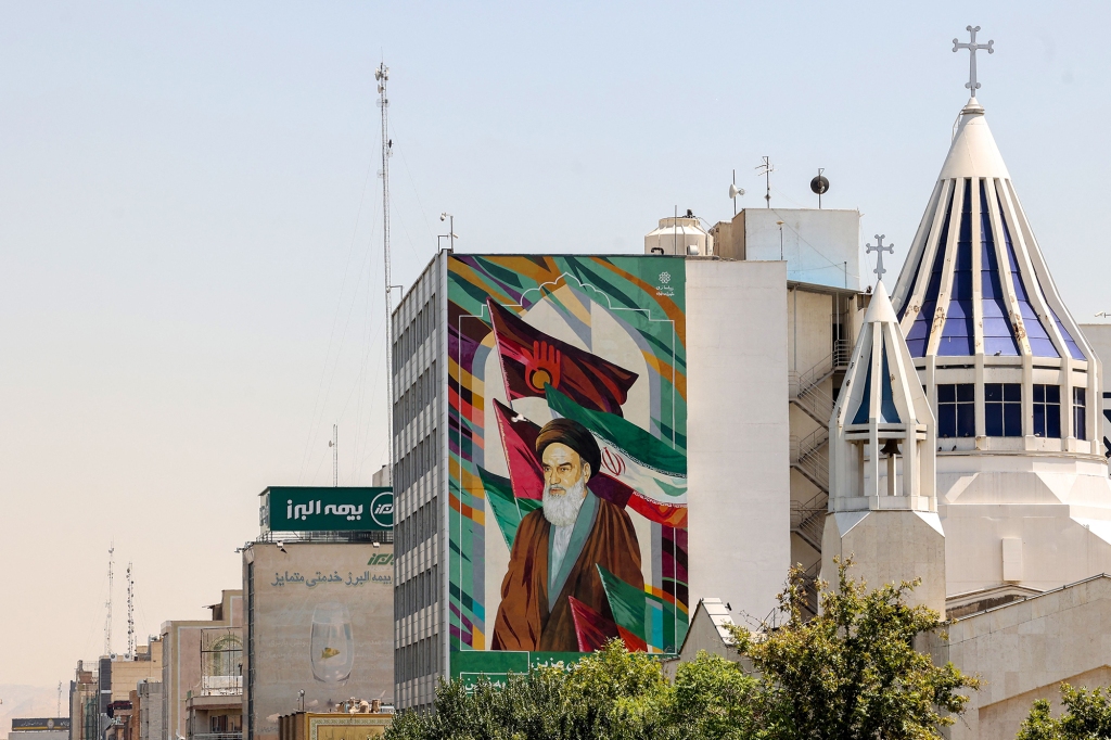 Iran with building showing Iranian flag.